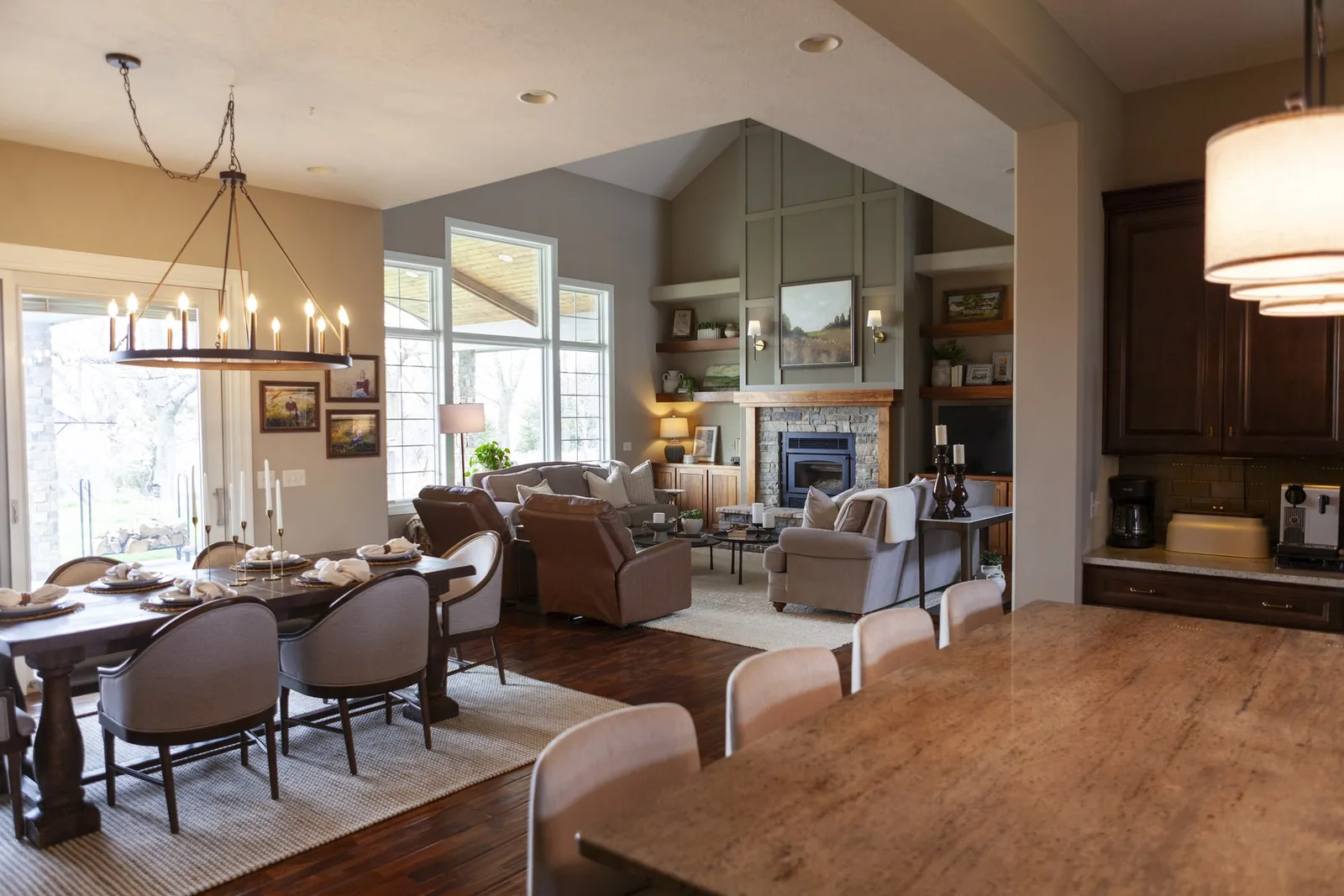 Full-service great room with stone fireplace and sage built-ins by Willow & Stone Interiors, Omaha